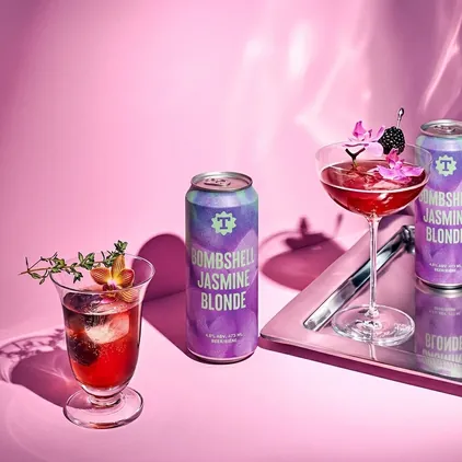Bombshell Jasmine Blonde beer styled with cocktails on a pink set, beverage branding by Renuvo Design Inc.
