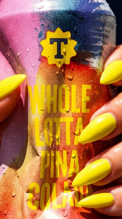 Whole Lotta Pina Colada beer can held with bright yellow nails, beverage branding by Renuvo Design Inc.
